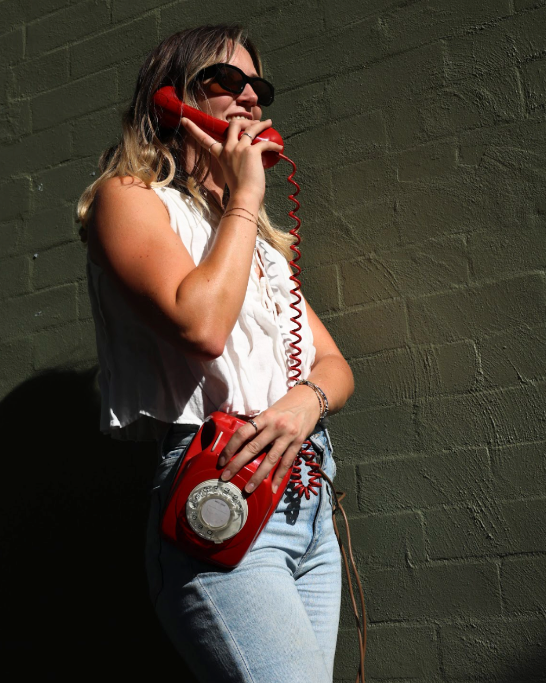 Core Studios social team on a red rotary telephone