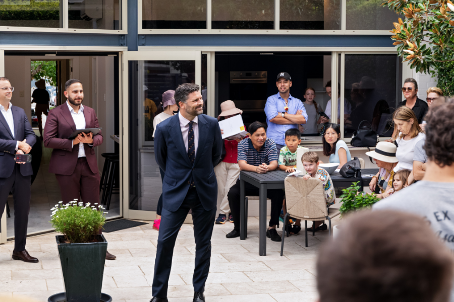 Agent addressing a crowd at an auction